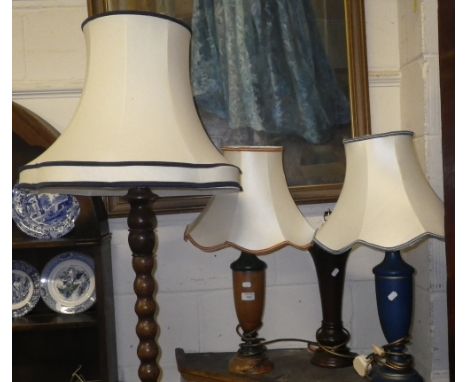 Three contemporary table lamps and a carved oak standard lamp  