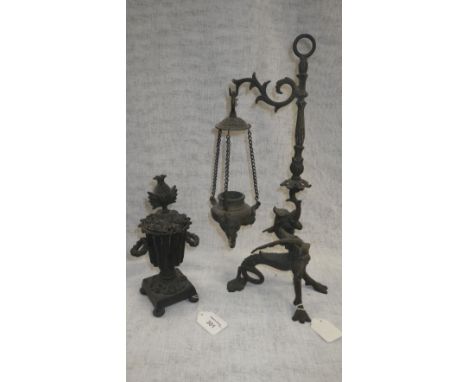 A Victorian cast-iron ornament in the form of a lidded vase on square base and a hanging oil lamp