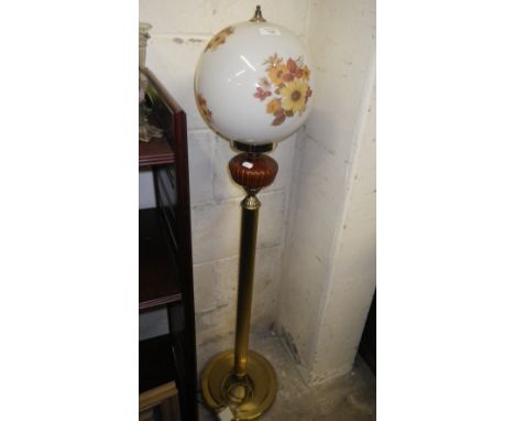 A brass effect Victorian style floor standing lamp with floral decorated shade 