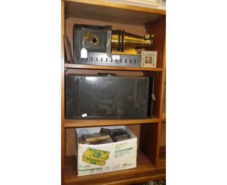 A Victorian Magic Lantern in Japanned case, and a quantity of slides