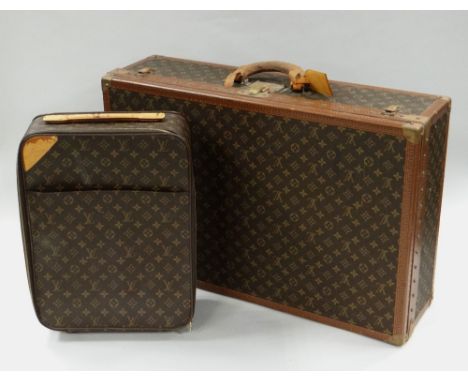 LATE TWENTIETH CENTURY LOUIS VUITTON SUITCASE in the typical logo & floral motif design, having a leather handle & luggage ta