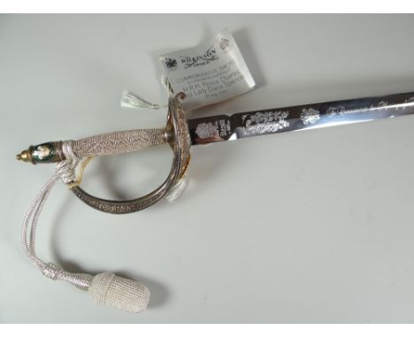 A 1981 WILKINSON COMMEMORATIVE SWORD for the wedding of Prince Charles and Lady Diana with inscription to the blade and the h