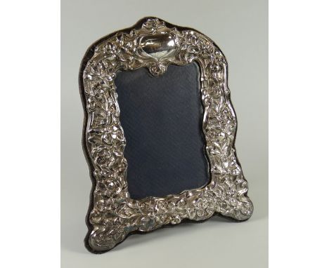 A MODERN REPRODUCTION SILVER EASEL PORTRAIT FRAME with raised Victorian style decoration, Birmingham 1996, 23cms high