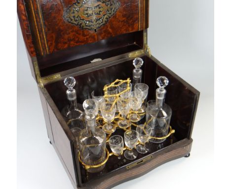 A NAPOLEON III PERIOD WALNUT MARQUETRY LIQUOR CABINET having a folded hinged lid & flanking cabinet doors, internally the gla
