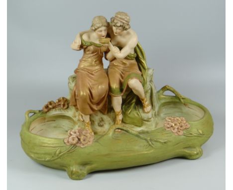 ROYAL DUX FIGURAL BASIN in typical blush glaze & with two robed companions one consoling the other with a bowl of food / wate