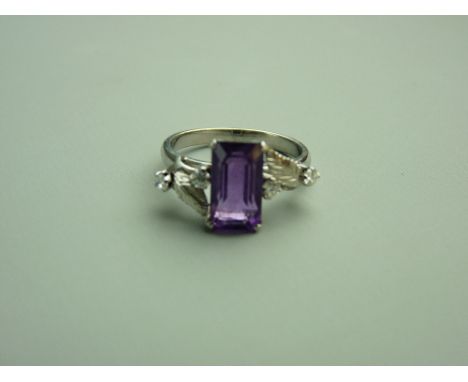 A FOURTEEN CARAT WHITE GOLD AMETHYST & DIAMOND DRESS RING, the emerald cut moderate purple amethyst approximately 11.3 x 6.4m