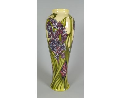 A 2012 MOORCROFT LIMITED EDITION NARROW NECKED BALUSTER VASE in the Hyacinth pattern from the Legacy Collection, signed by K 