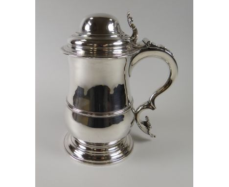 A RARE GEORGE III SILVER TANKARD by William Grundy, 1766 of baluster form on spreading circular foot, the body applied with m