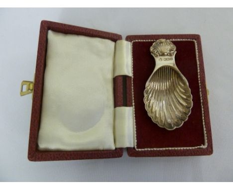 A cased silver caddy spoon, fluted bowl with shell terminal, Sheffield 1971