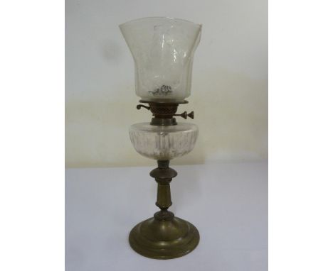A Victorian brass and glass oil lamp on raised circular base