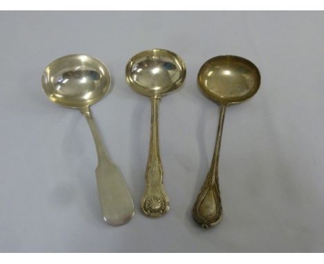 A William IV Irish silver fiddle pattern sauce ladle, a George IV Scottish silver Kings pattern sauce ladle and a silver Lily