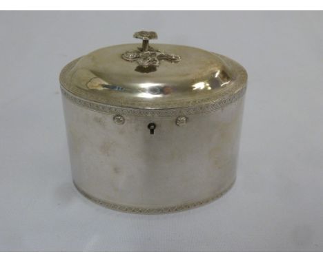 A rare 18th century York silver tea caddy of oval form, engraved chevron bands, the raised hinged cover with floral finial, h