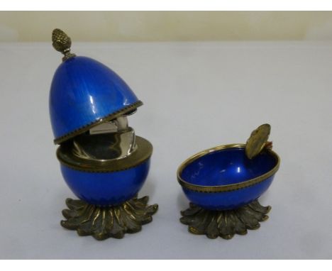 An American gilt metal and enamel table lighter and matching ashtray