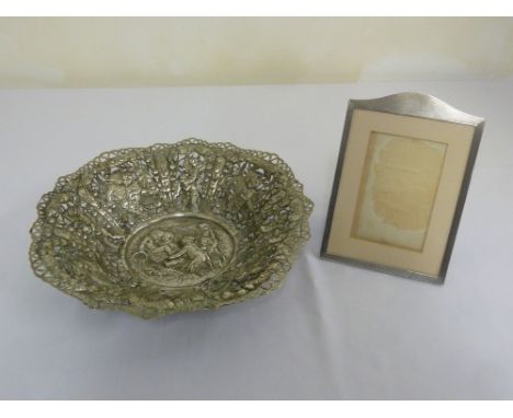 A silver engine turned photograph frame and a silver plated decorative dish in the Dutch style
