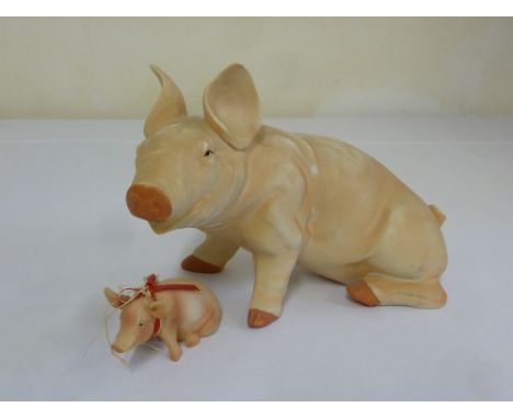Ceramic seated pig and another