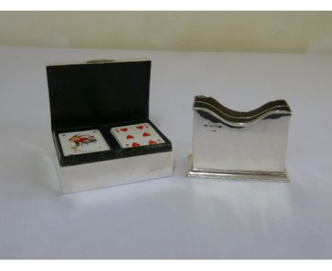 A silver playing card case and a silver card stand