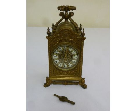 French brass carriage clock with Arabic numerals, the profusely decorated case on four lion paw feet with pierced scroll carr