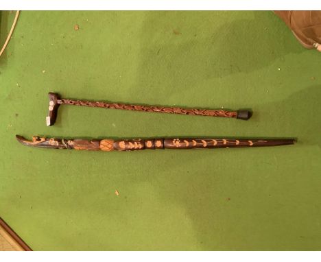 A CARVED WOODEN WALKING STICK FEATURING A CAT HANDLE AND A WOODEN SNAKE HANDLE WALKING STICK WITH ORNATE CARVING JAMAICA 