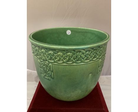 A PILKINGTONS LANCASTRIAN POTTERY GREEN JARDINERE WITH A MOULDED CELTIC DESIGN 