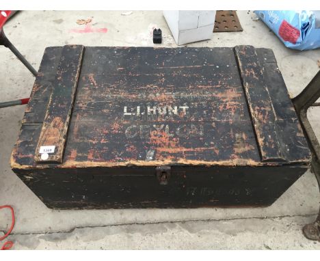 A VINTAGE WOODEN TRUNK WITH GALVANISED LINER, NAMED "L I HUNT, CEYLON" 