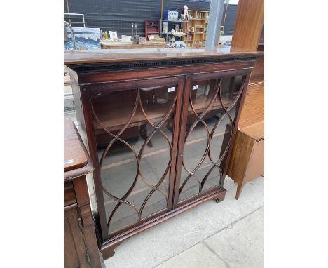 A 19TH CENTURY MAHOGANY AND INLAID TWO DOOR GLAZED BOOKCASE ON BRACKET FEET WITH DENTIL CORNERS, 46.5" WIDE 