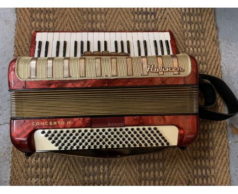 A VINTAGE ACCORDION IN A CARRY CASE 