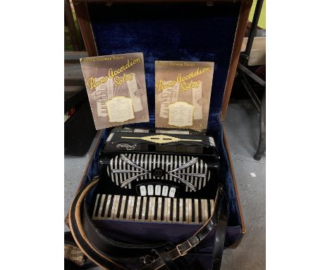 A VINTAGE ACCORDION IN A LEATHER EFFECT CARRY CASE 