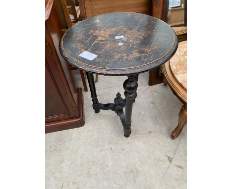 A VICTORIAN ROUND EBONISED OCCASIONAL TABLE, 21" DIAMETER, ON TURNED BASE, THE TOP HAVING INDISTINCT PAINTED CRESTS 