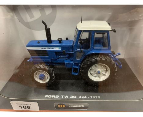A BOXED UNIVERSAL HOBBIES DIE CAST FORD TRACTOR 1:32 
