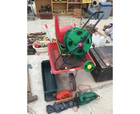 A WHEELBARROW, HEDGE TRIMMER, HOSE REEL AND VARIOUS GARDEN TOOLS 