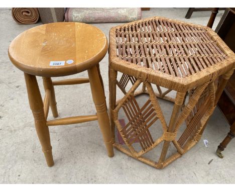 A BEECH STOOL AND A SMALL WICKER TABLE 