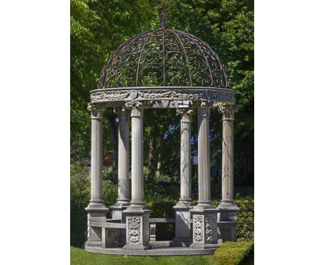 A carved limestone and wrought iron mounted garden rotunda, 20th century, the wrought iron openwork dome formed of segments o