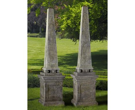 A pair of Continental limestone obelisks, 20th century, of tapering square section form, each above a panel sided pedestal, 3