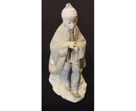 Nao Eskimo boy with flute, H: 24 cm. P&amp;P Group 2 (£18+VAT for the first lot and £3+VAT for subsequent lots) 