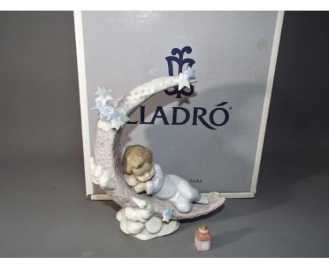 Lladro - a ceramic Lladro figurine, entitle Heavenly Slumber #06479, with certificate in original box.