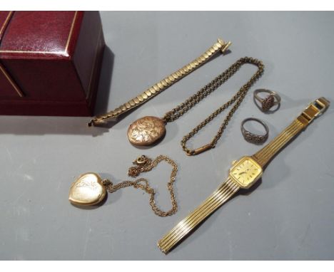 A mixed lot to include two silver dress rings set with marcasite, two yellow metal lockets, a chain, a watch bracelet and a R