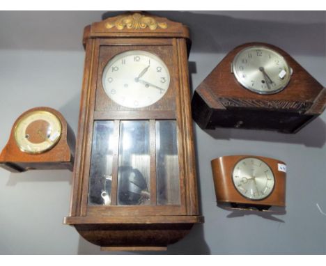 An oak case wall clock with pendulum and key, a retro oak case mantle clock with pendulum and key, a Smiths mantle clock and 