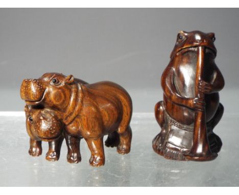 Netsuke - two vintage Japanese dark wood Netsuke figures one depicting a frog playing a musical instrument the other depictin