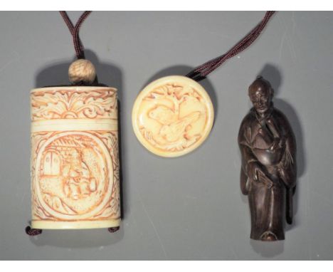 Netsuke - a collection of Japanese items comprising a bone Inro with depictions of an Oriental gentleman on both sides, a but
