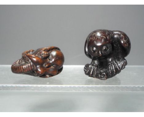 Netsuke - two vintage dark wood Japanese Netsukes one depicting a coiled octopus or squid and the other depicting an owl, bot