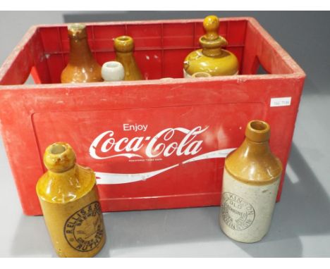 Breweriana - a Coca Cola branded crate, containing a quantity of ceramic jugs, tanker by TJ Green.