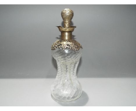 An Edward VII, clear wrythen glass and silver cluck cluck decanter with quatrefoil silver hallmarked pouring spout, Birmingha