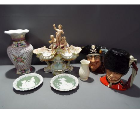 A lot to include two Royal Doulton character jugs comprising The Guardsman D6755 and Long John Silver D6355, a European ceram