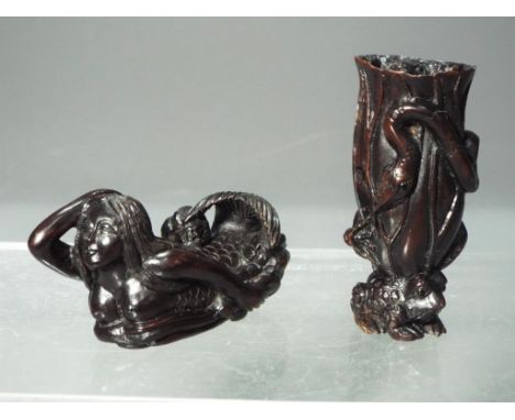 Netsuke - a collection of two dark wood Japanese Netsukes one depicting a small frog carrying a tree trunk with a frog on the