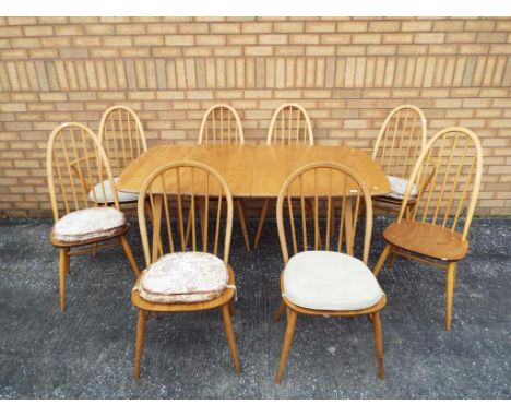 A Ercol extending dining table and eight chairs, table approximately 72 cm x 91 cm x 152 cm (extending to 224).Condition: som