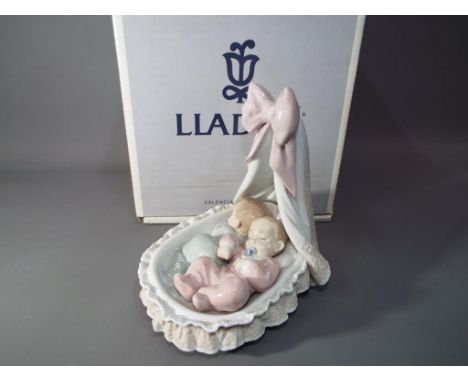 Lladro - a ceramic Lladro figurine entitles Sweet Dreamers with certificate of authenticity in original box.