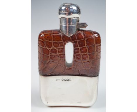 A George V silver-mounted hip flask, of typical form with hinged cap with bayonet catch, reptile skin covered shoulders with 