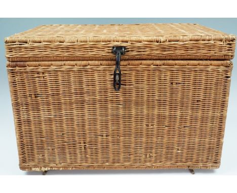 A woven box containing a large quantity of new-old-stock and as-new vintage babies' clothing, toys, pram sets etc, many items