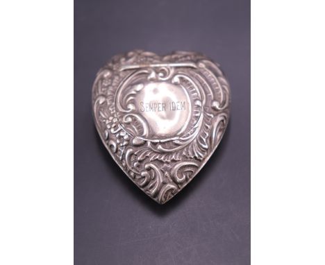 A late Victorian silver heart-shaped patch or similar box, each face relief-decorated in a rococo pattern centred by a cartou