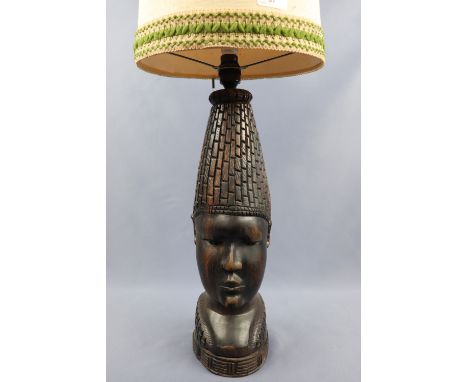 A large African carved hardwood table lamp modelled as a bust, 42 cm to socket